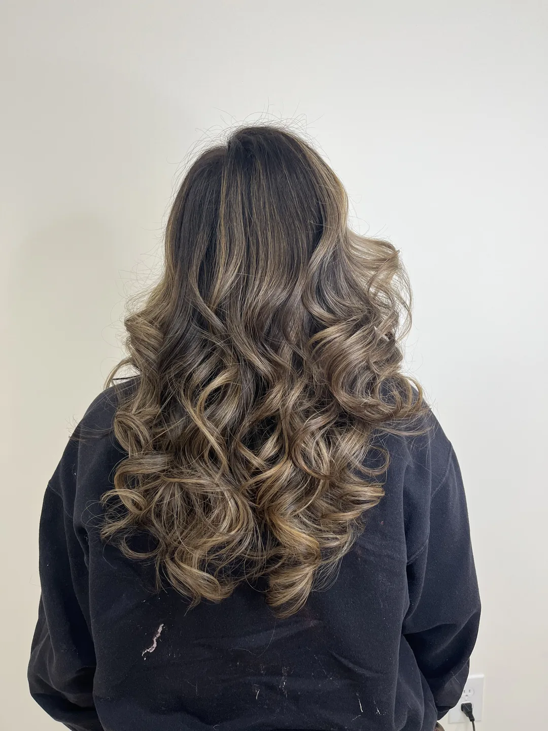 brunette-to-blonde balayage with curled lengths