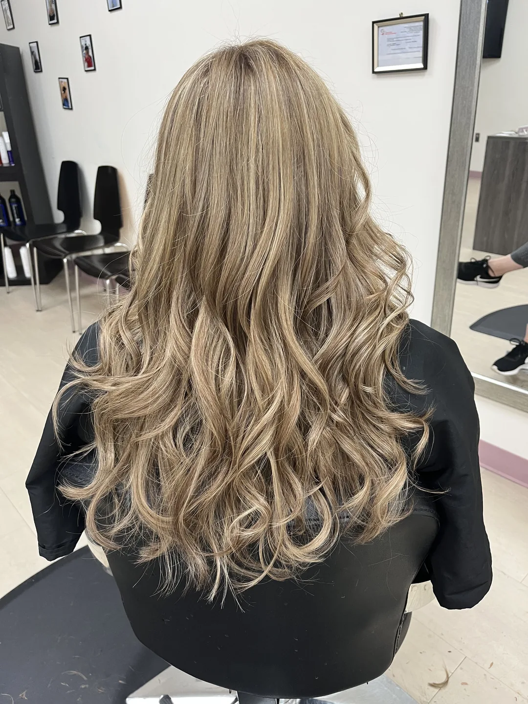 warm honey blonde balayage on long curled hair