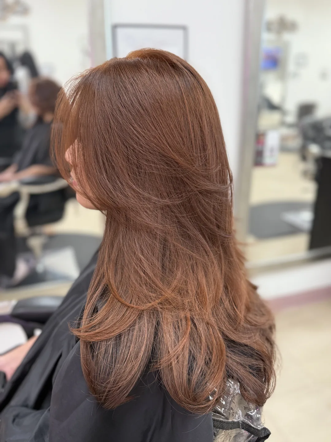 rich copper blonde color on long layered hair, back view