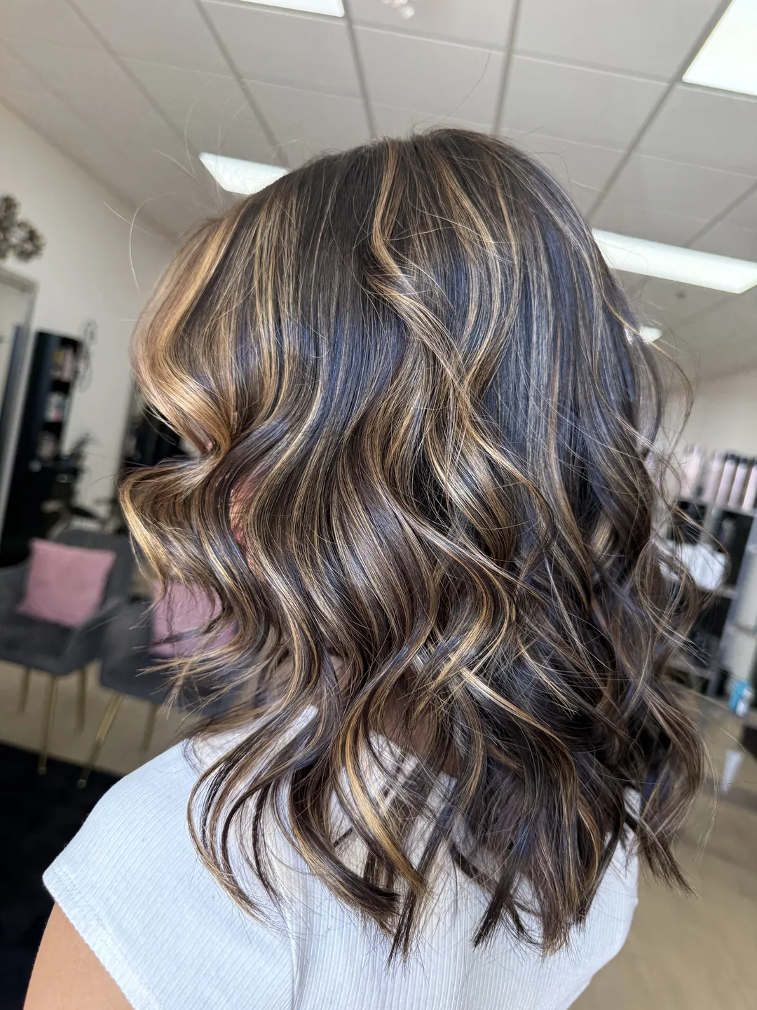 subtle honey blonde balayage on dark brunette waves