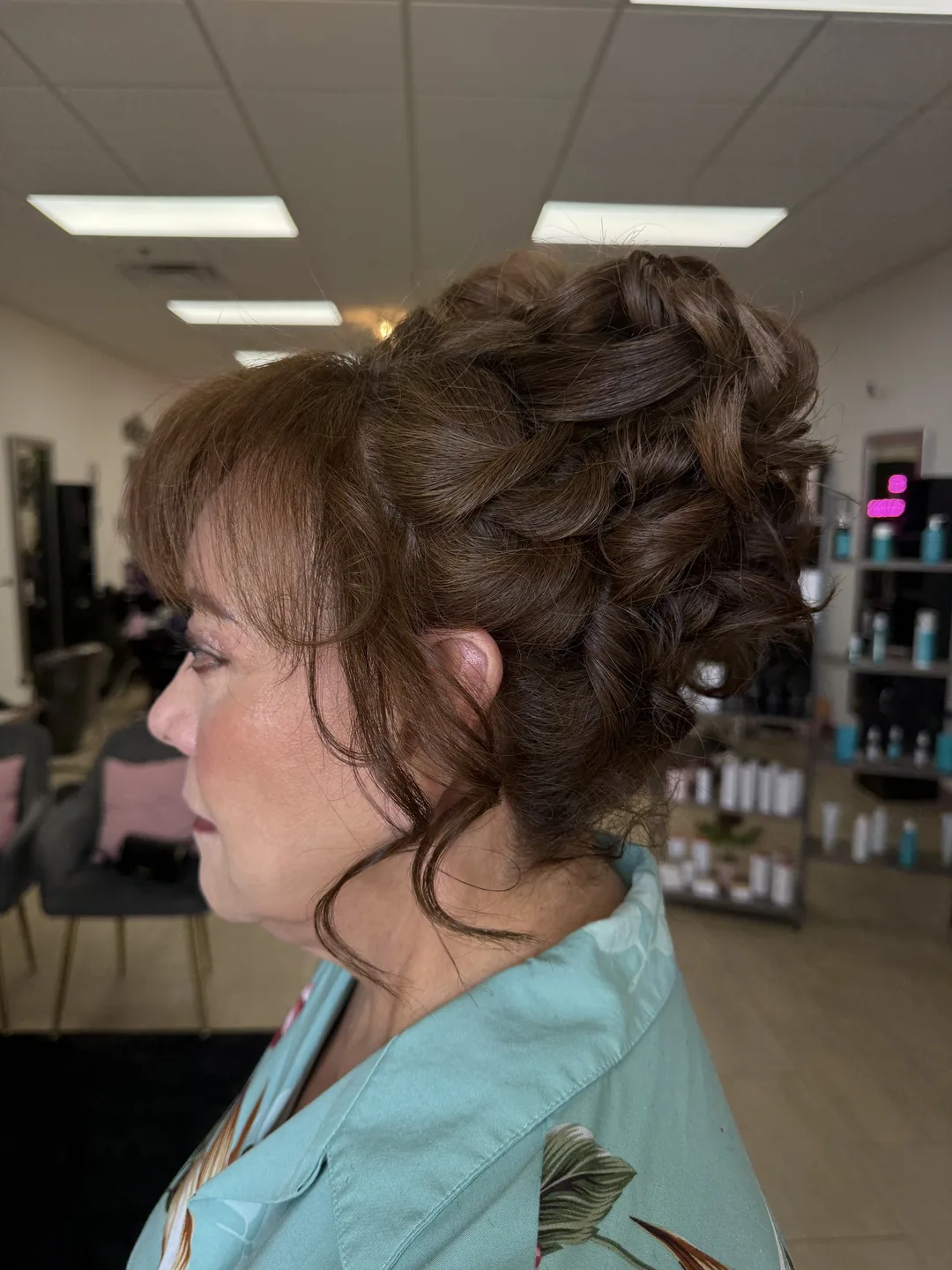 romantic braided bridal updo with soft face-framing pieces, side profile