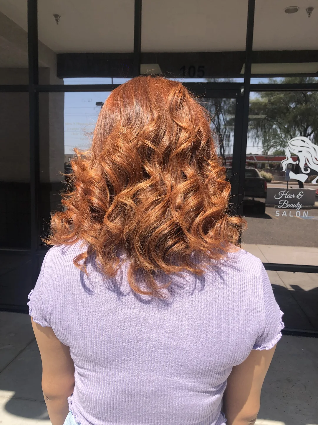 copper-red curls salon exterior with Luxe signage