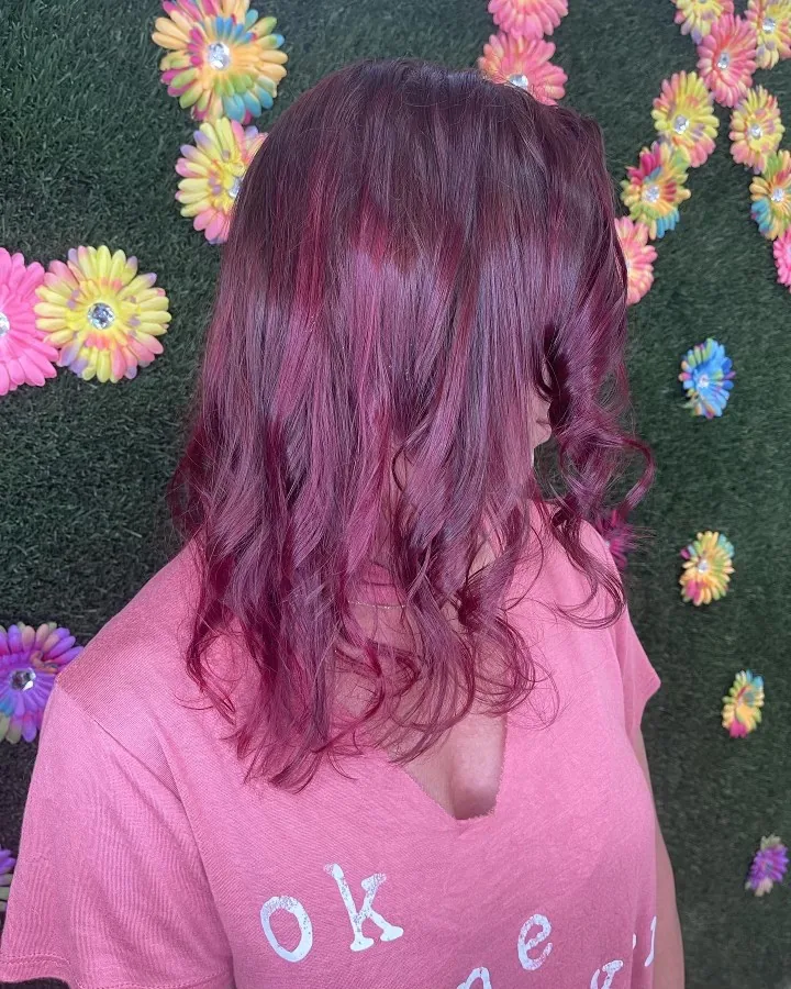 wine/magenta color on long waves against floral wall