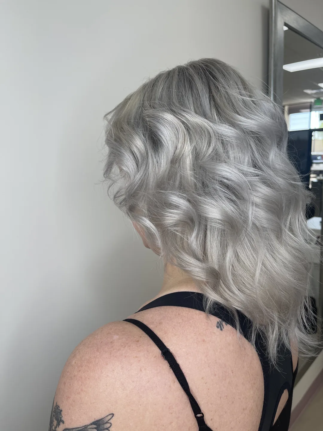 platinum silver waves with visible shoulder tattoo