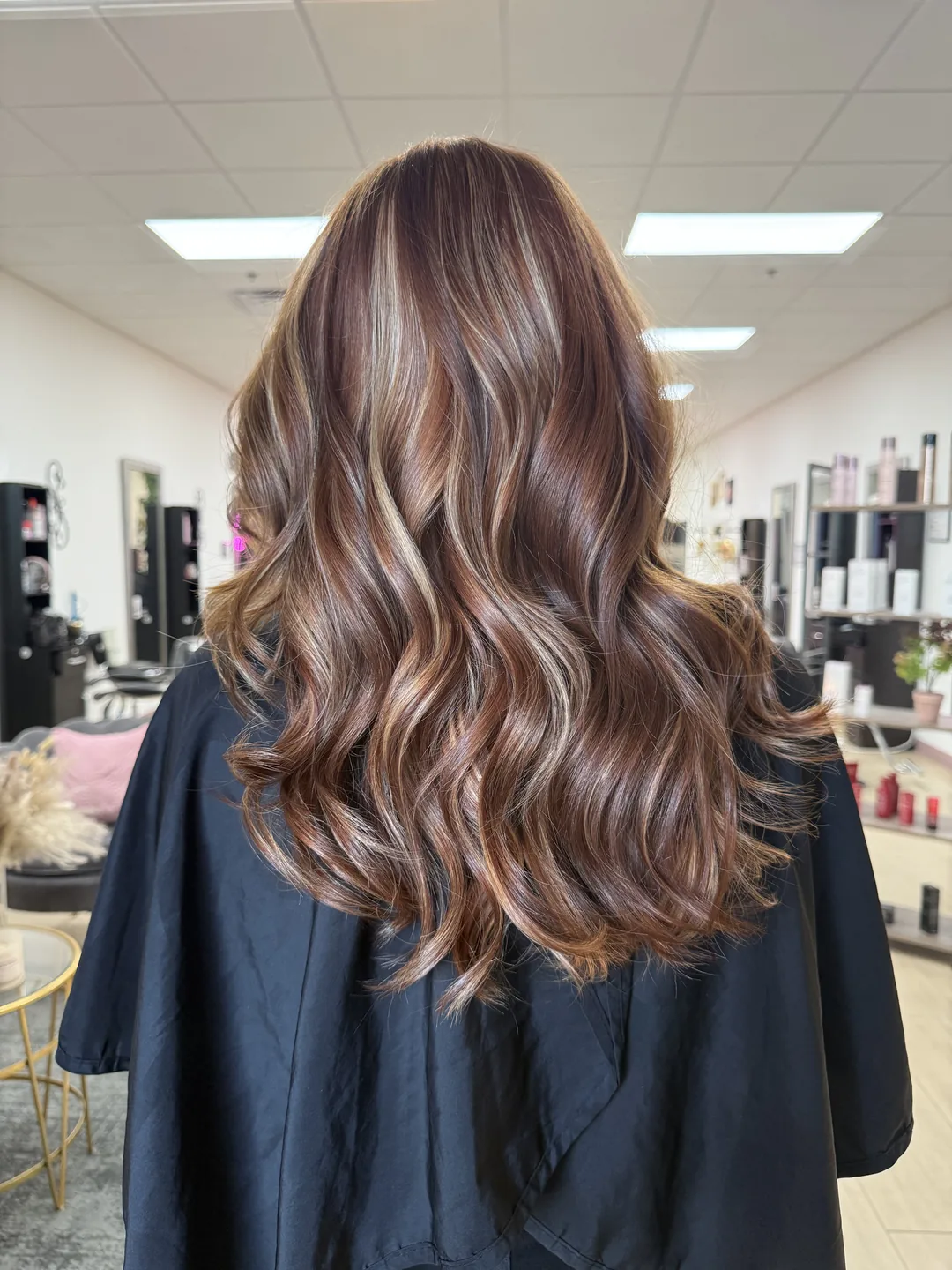 chestnut brunette balayage with blonde ribbons by Ellie Caraway, back view