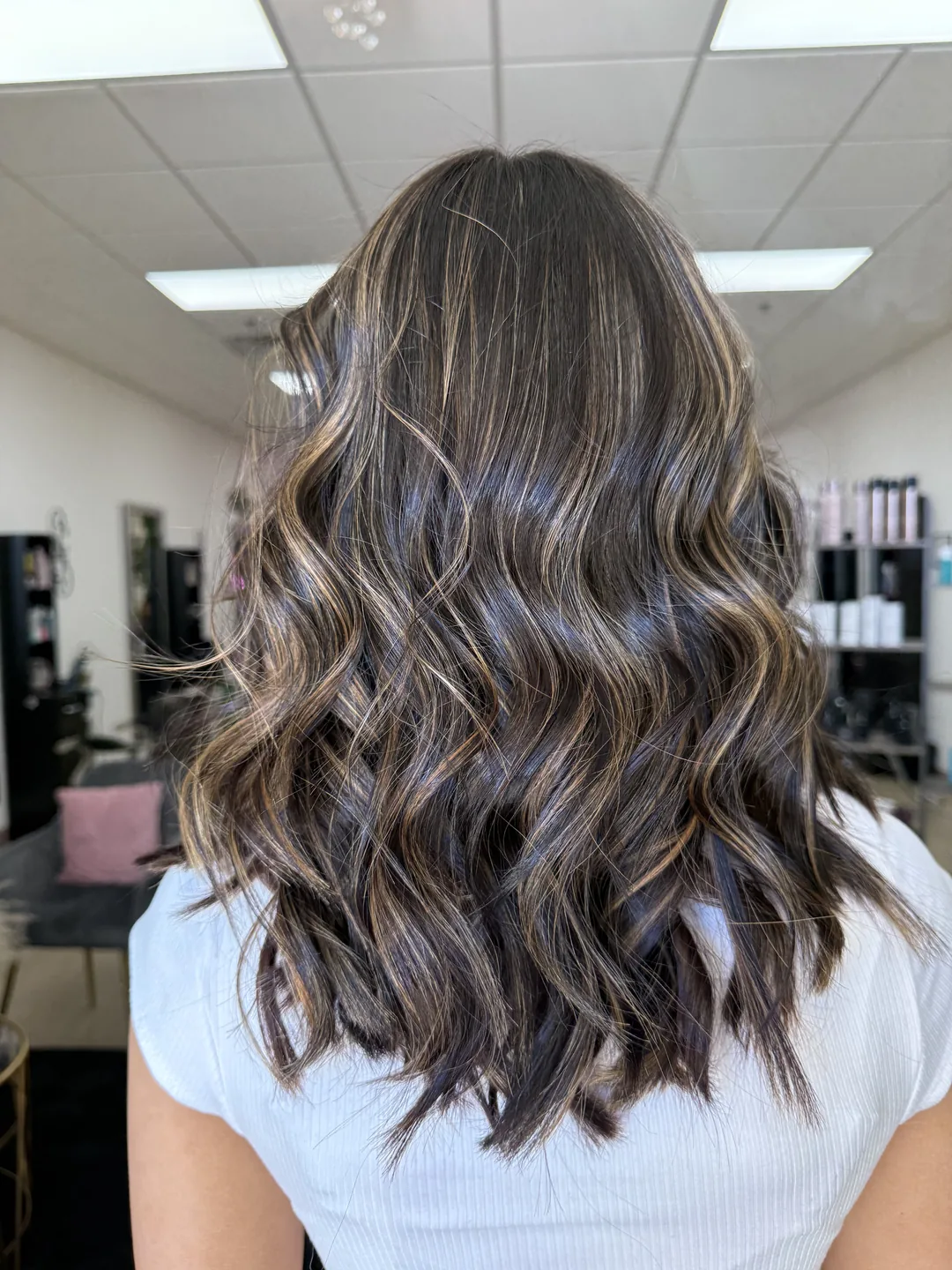 subtle caramel balayage on brunette beach waves, back view