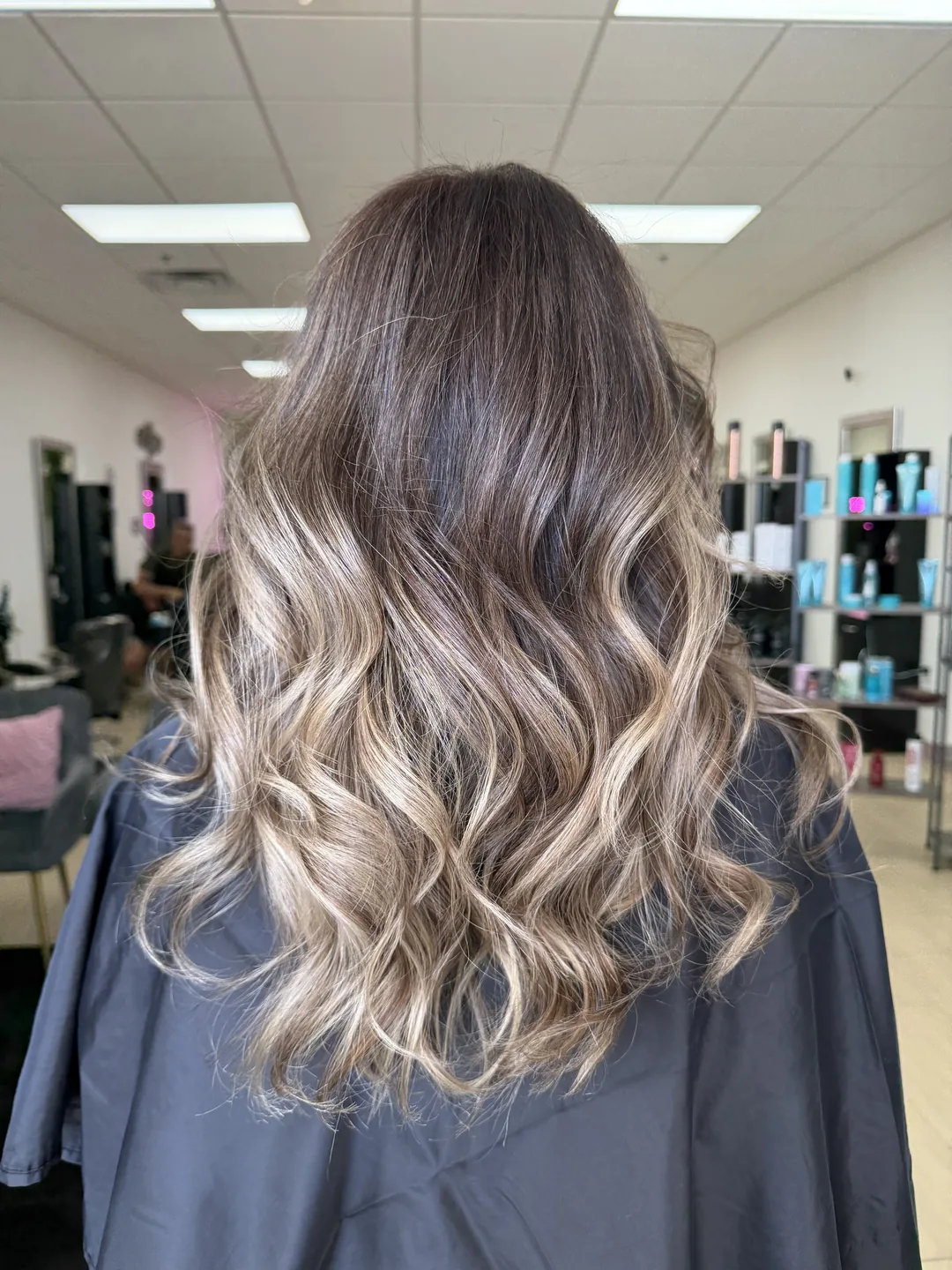 soft beach waves blowout style on balayage hair, back view