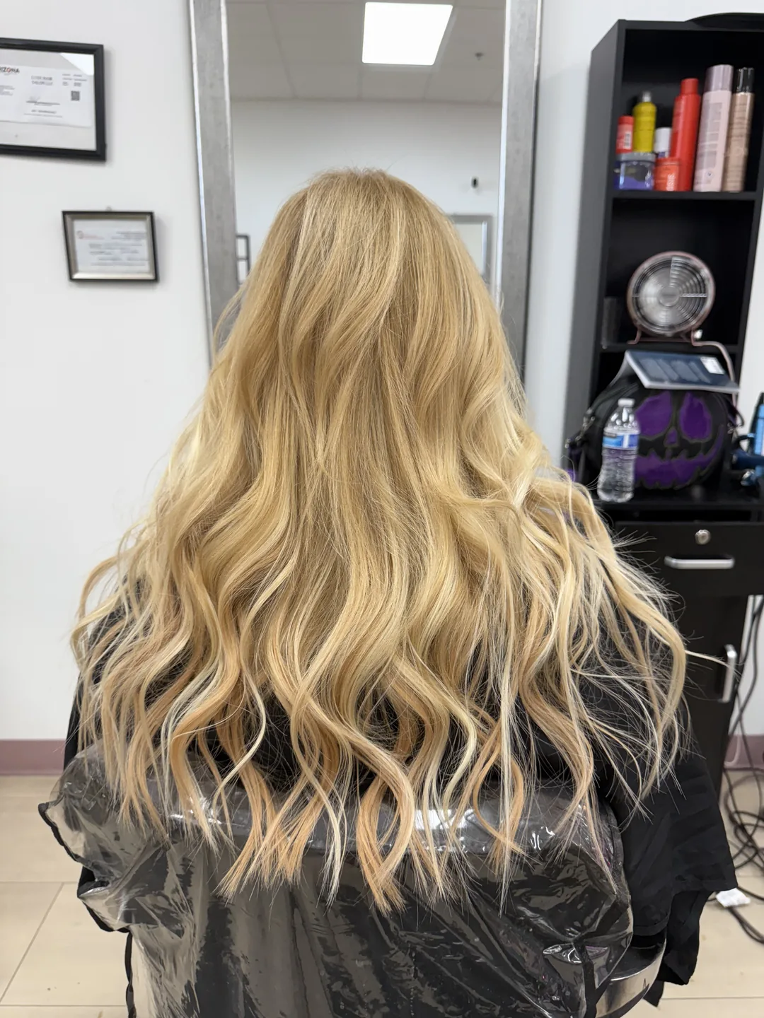 Long golden-blonde waves with added length and volume, back view