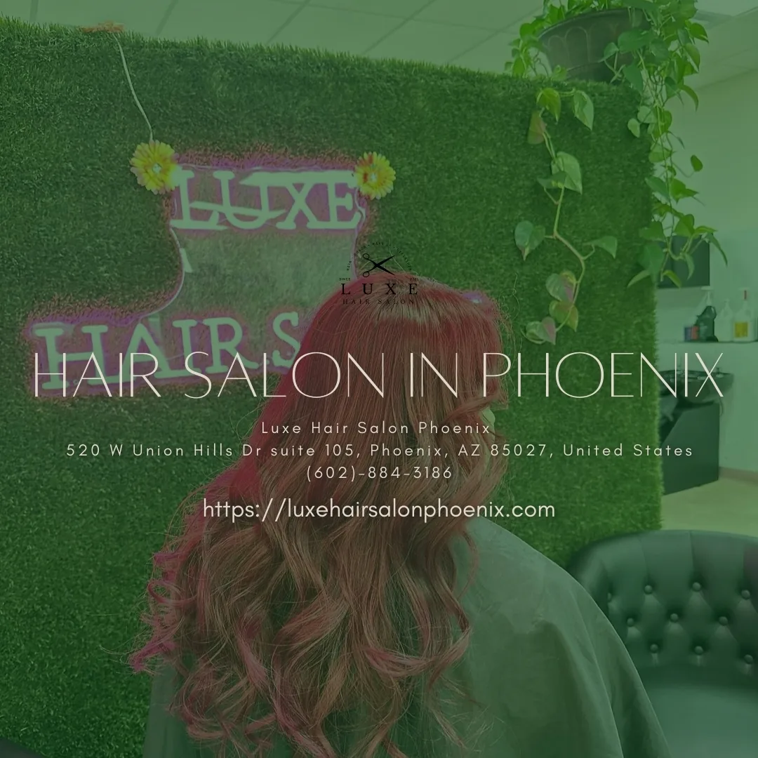 Long red wavy hair against greenery wall with Luxe neon sign